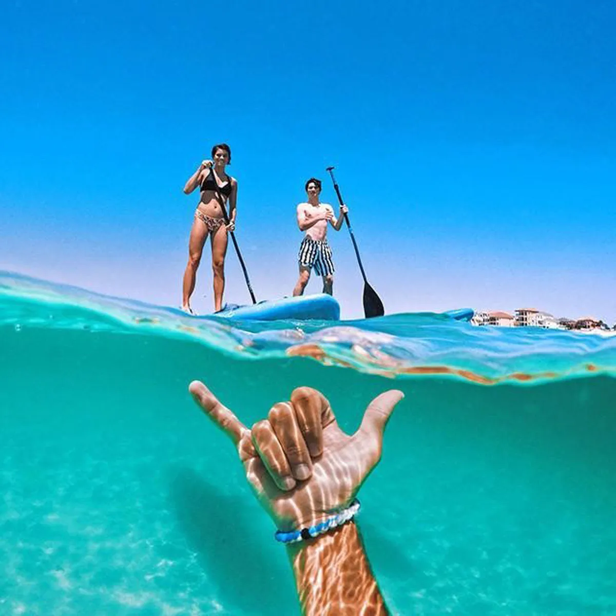 Over/under split shot taken with the GoPole DOME PRO, showing paddleboarders on the water.
