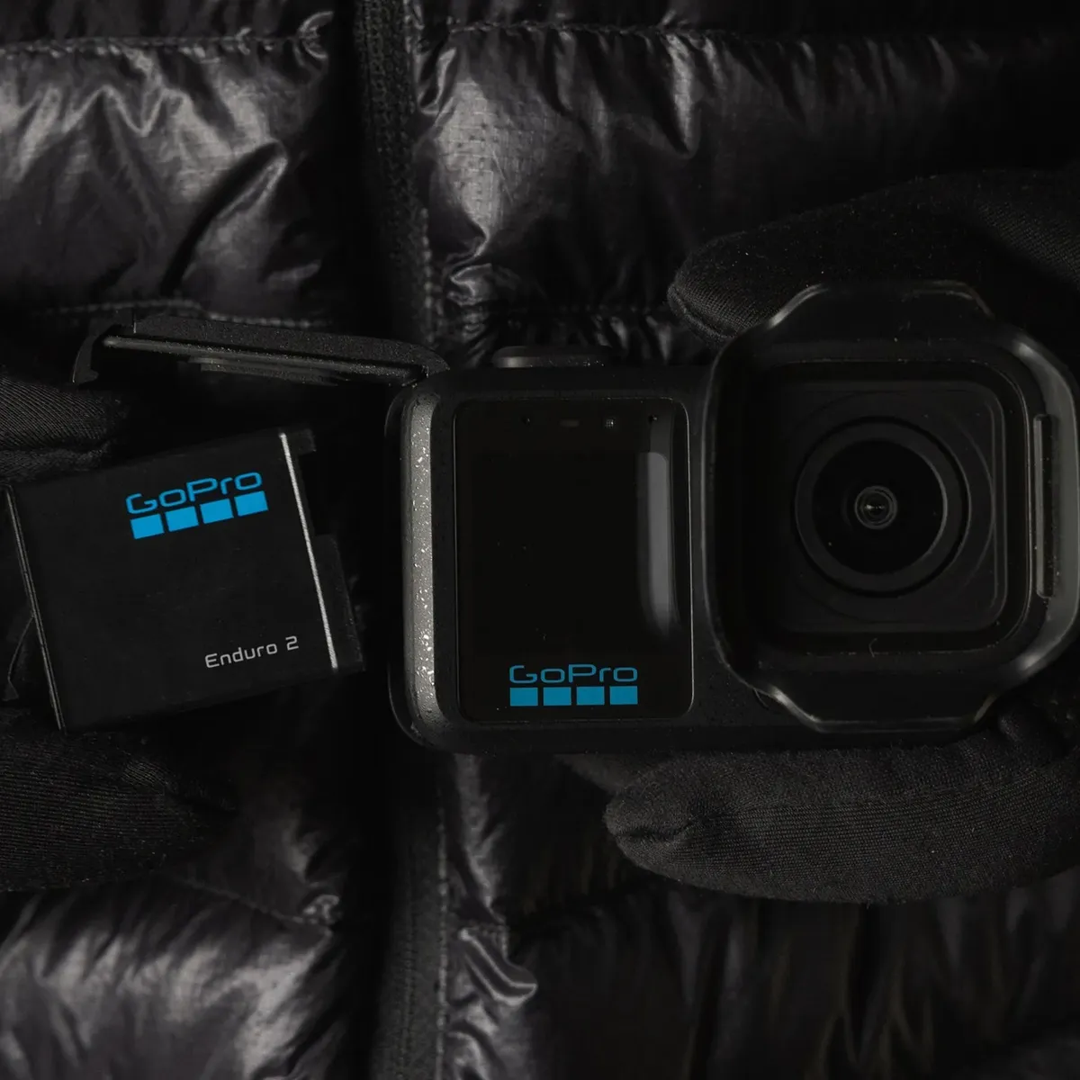 GoPro ENDURO2 Battery being fitted into a MISSION 1 camera, with gloves on.
