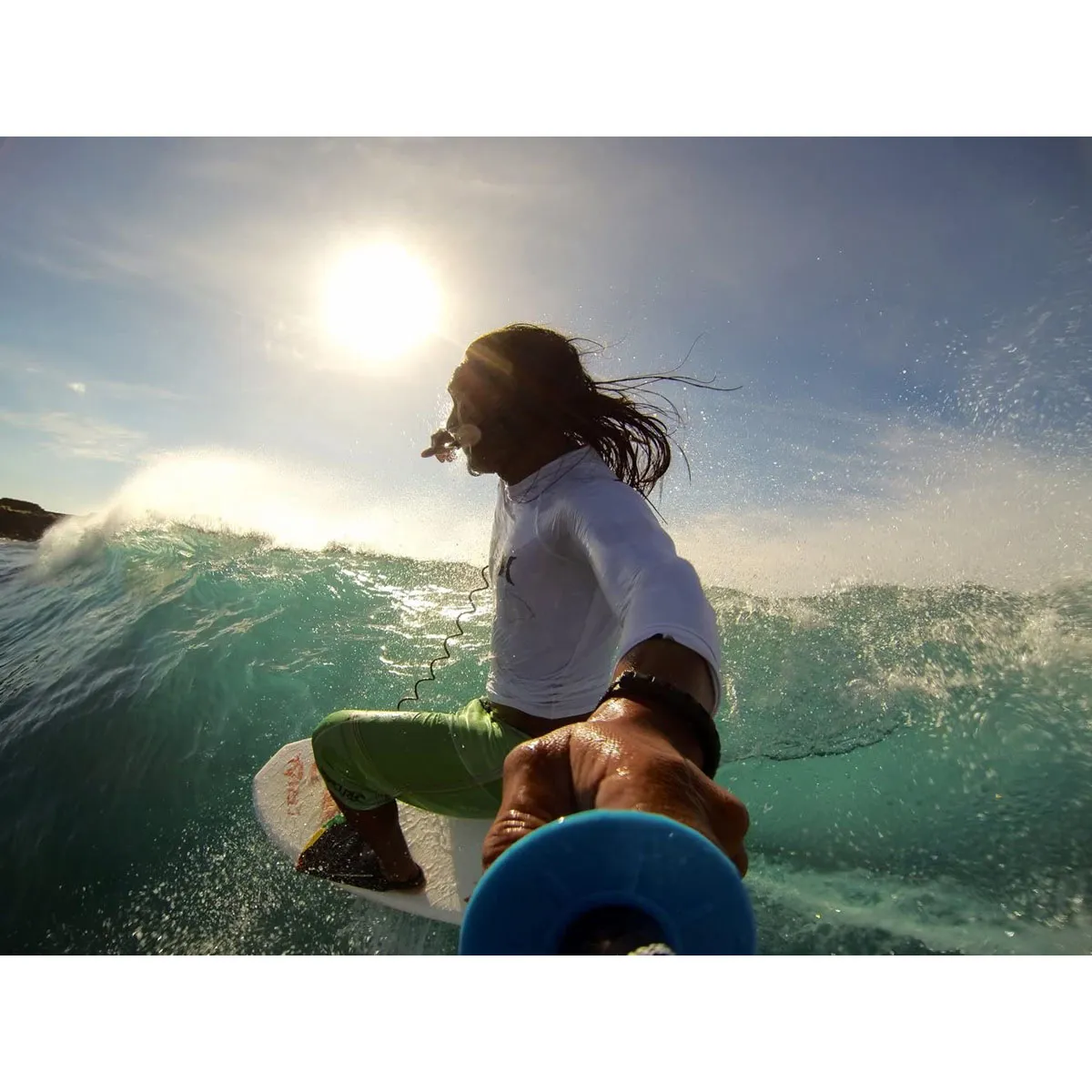 A surfer rides a wave, filmed with an action camera mounted on the UK Pro POLE 8.