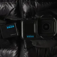 GoPro ENDURO2 Battery being fitted into a MISSION 1 camera, with gloves on.