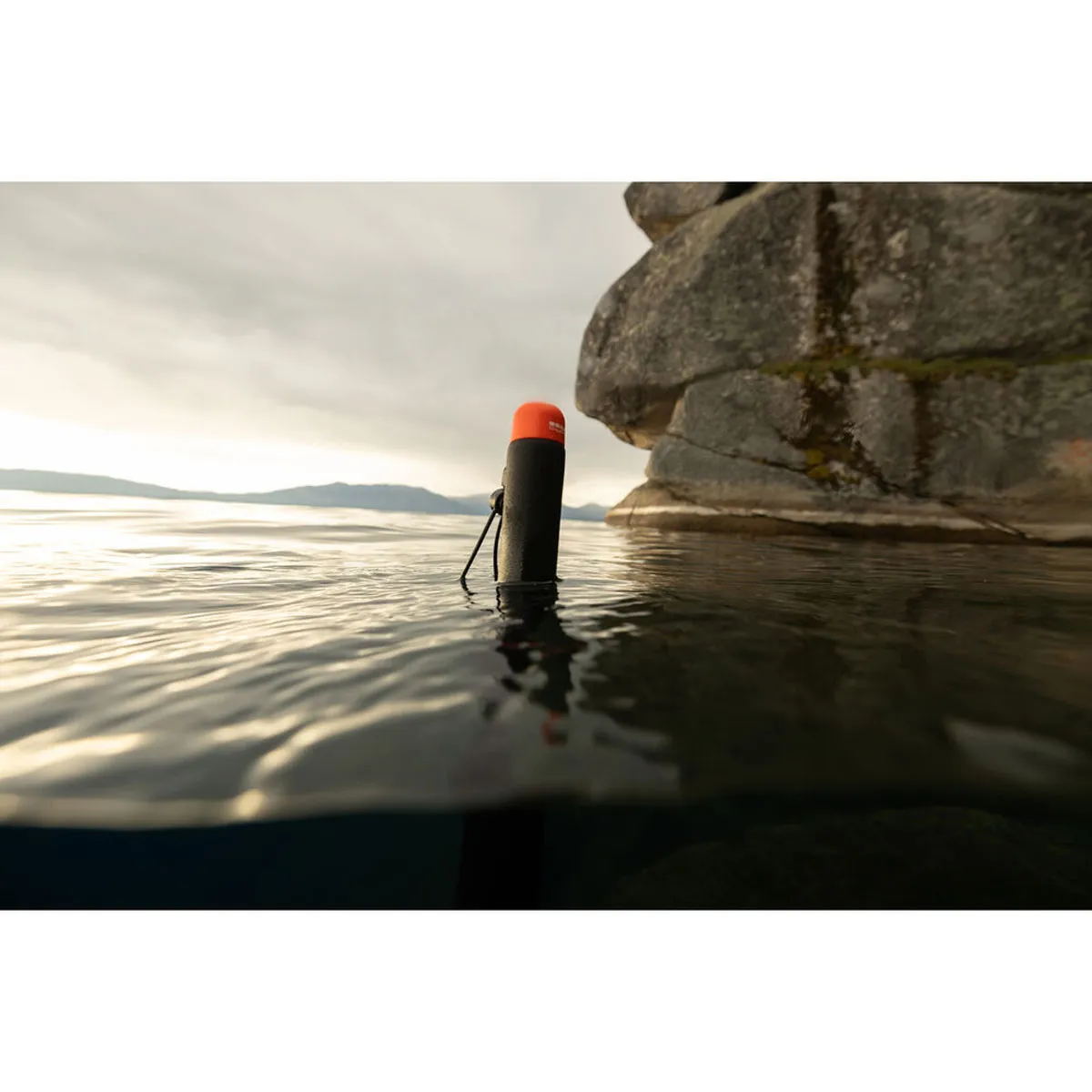 GoPro 80cm Floating Extension Pole floating in water with orange endcap visible above the surface.