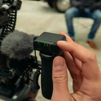 GoPro TRS Receiver mounted on a camera rig, adjusting gain during an interview setup.