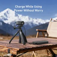 DJI Osmo Nano charging via a power bank while mounted on a mini tripod using the TELESIN quick release charging base.