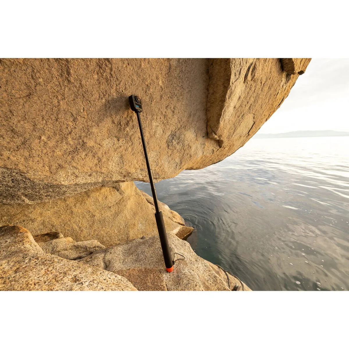 GoPro 80cm Floating Extension Pole extended with a 360 camera attached near the water.
