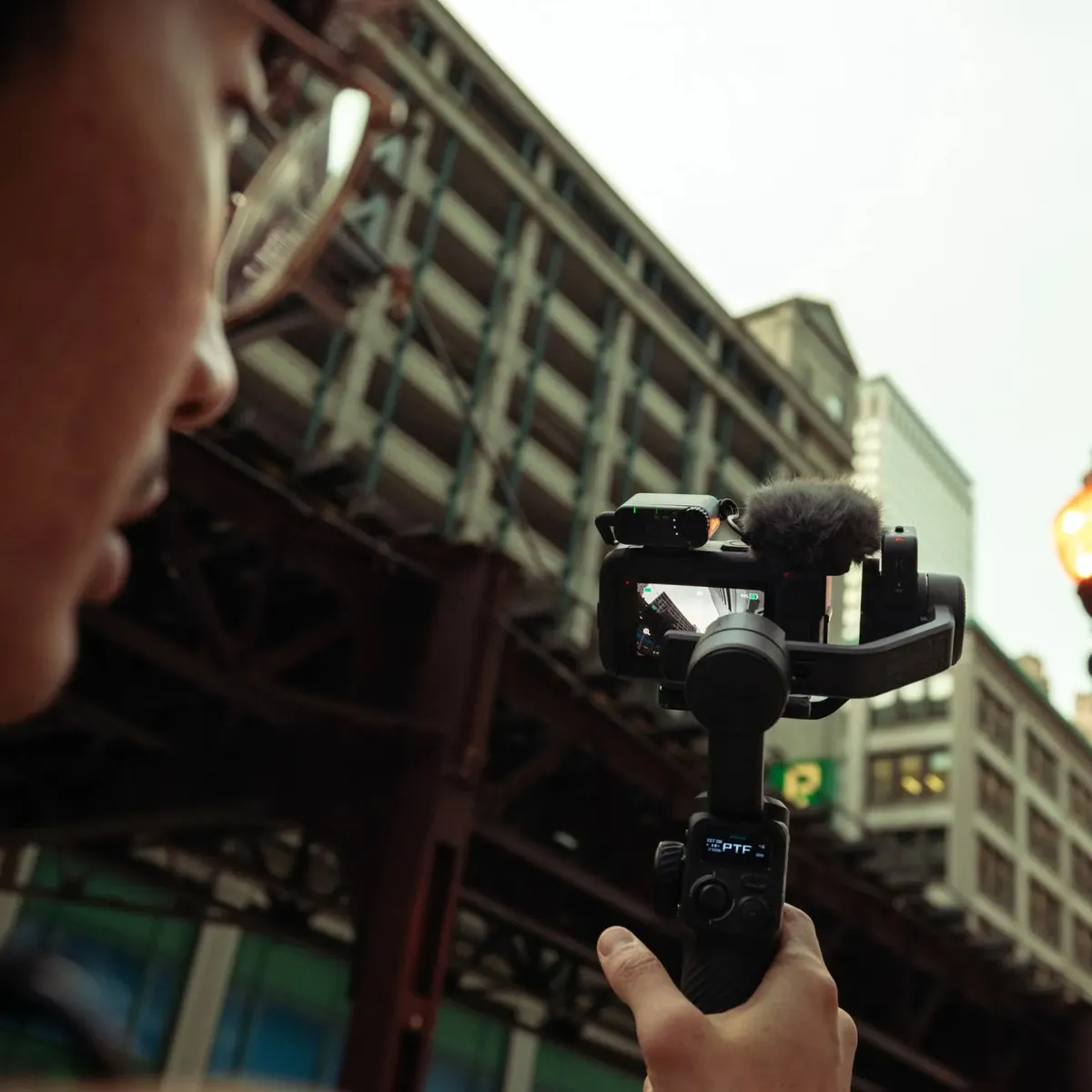 Creator filming in a city street with the GoPro TRS Receiver mounted on a gimbal-stabilised camera.