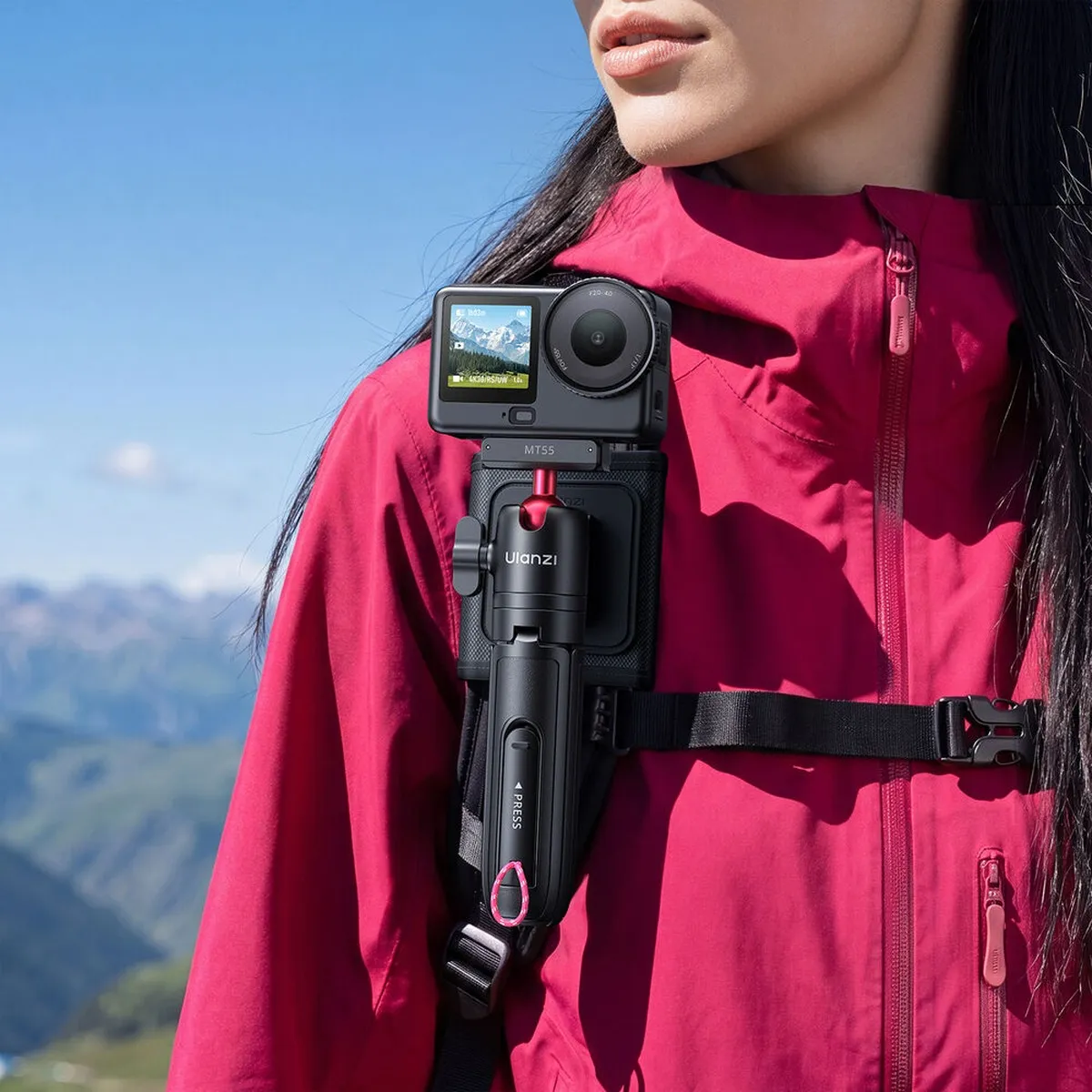 ULANZI SnapGo docked in the backpack strap mount with an action camera, worn on a shoulder strap.