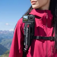ULANZI SnapGo docked in the backpack strap mount with an action camera, worn on a shoulder strap.