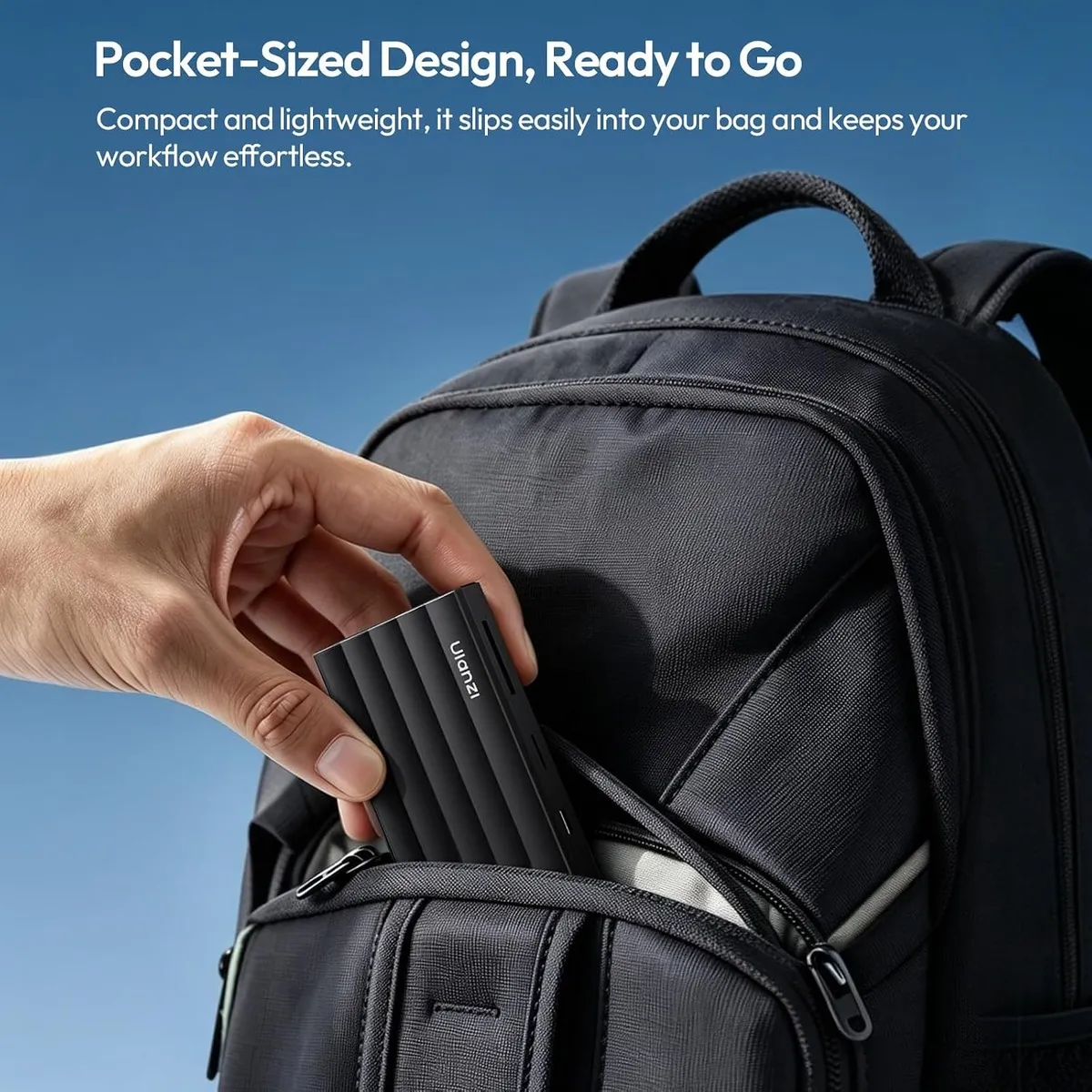 ULANZI DC04 memory card reader being slipped into a backpack pocket, showing its compact size.